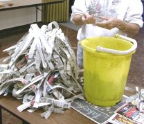 newspaper strips next to bucket