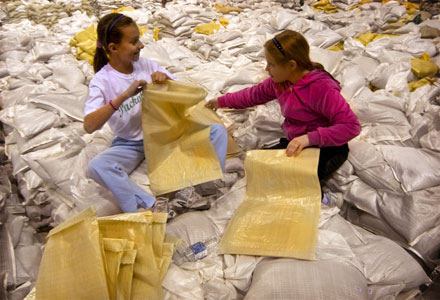 Children preparing sand bags