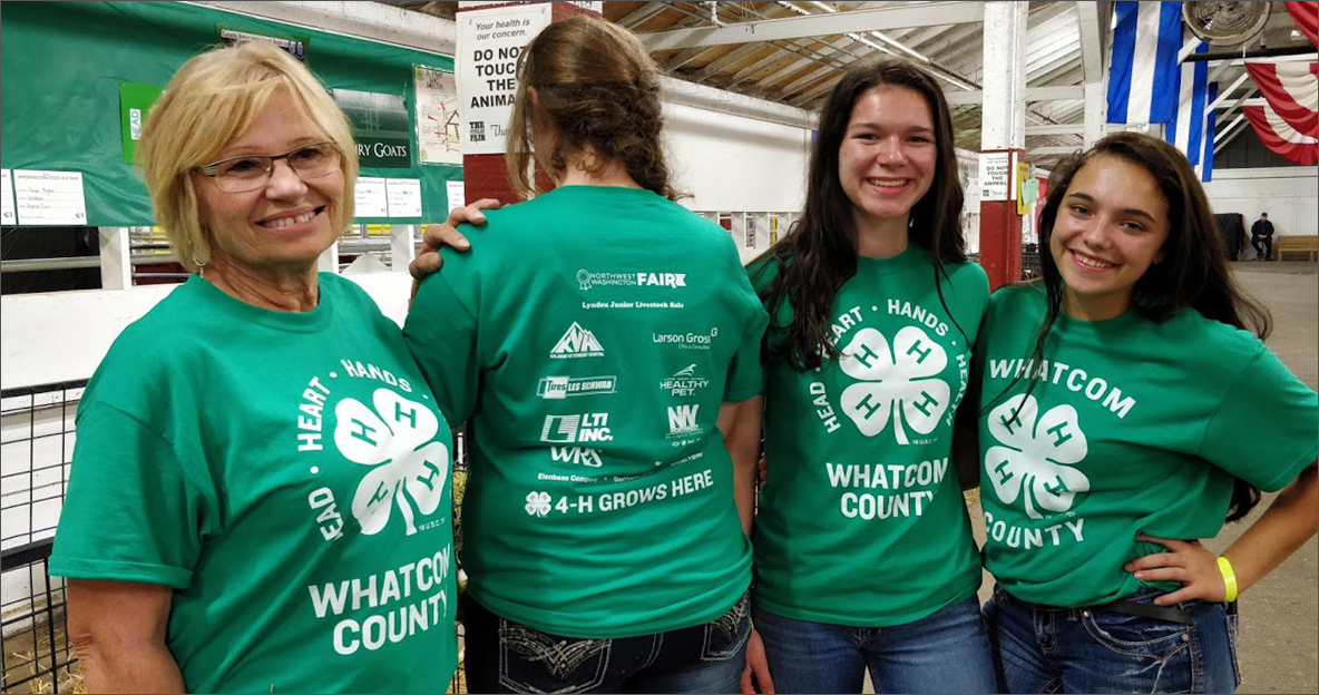 Four women wearing matching 4-H shirts
