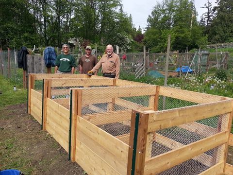 Composters standing by newly constructed bins