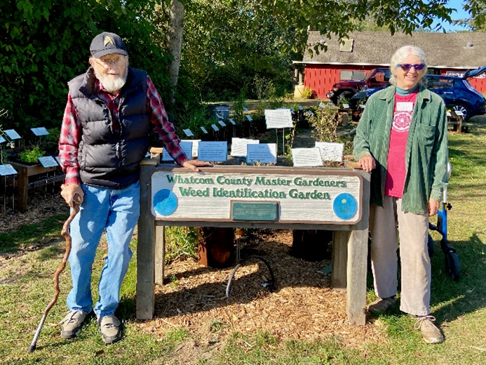 Master Gardeners posing in front of the Weed Identification Garden.