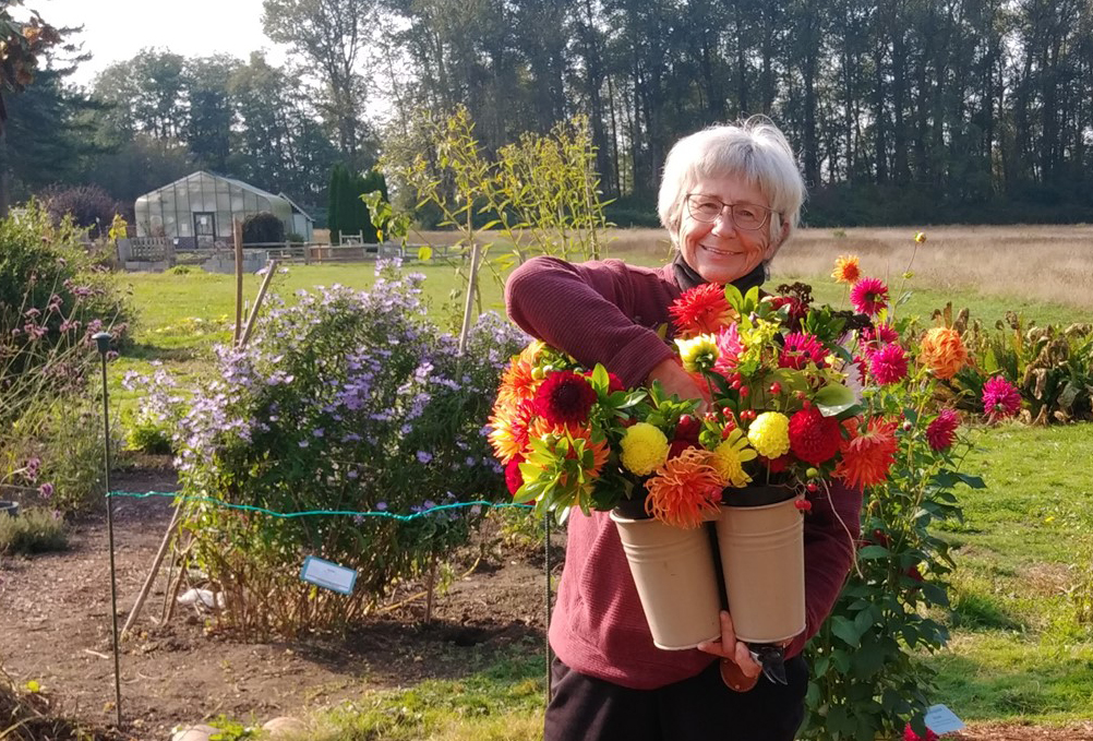 Woman holding buckets of flowers