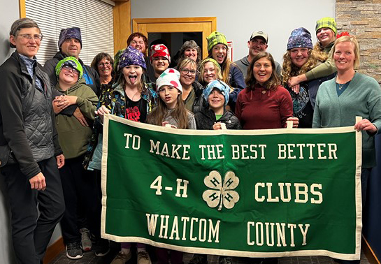 4-H members wearing winter hats they made.