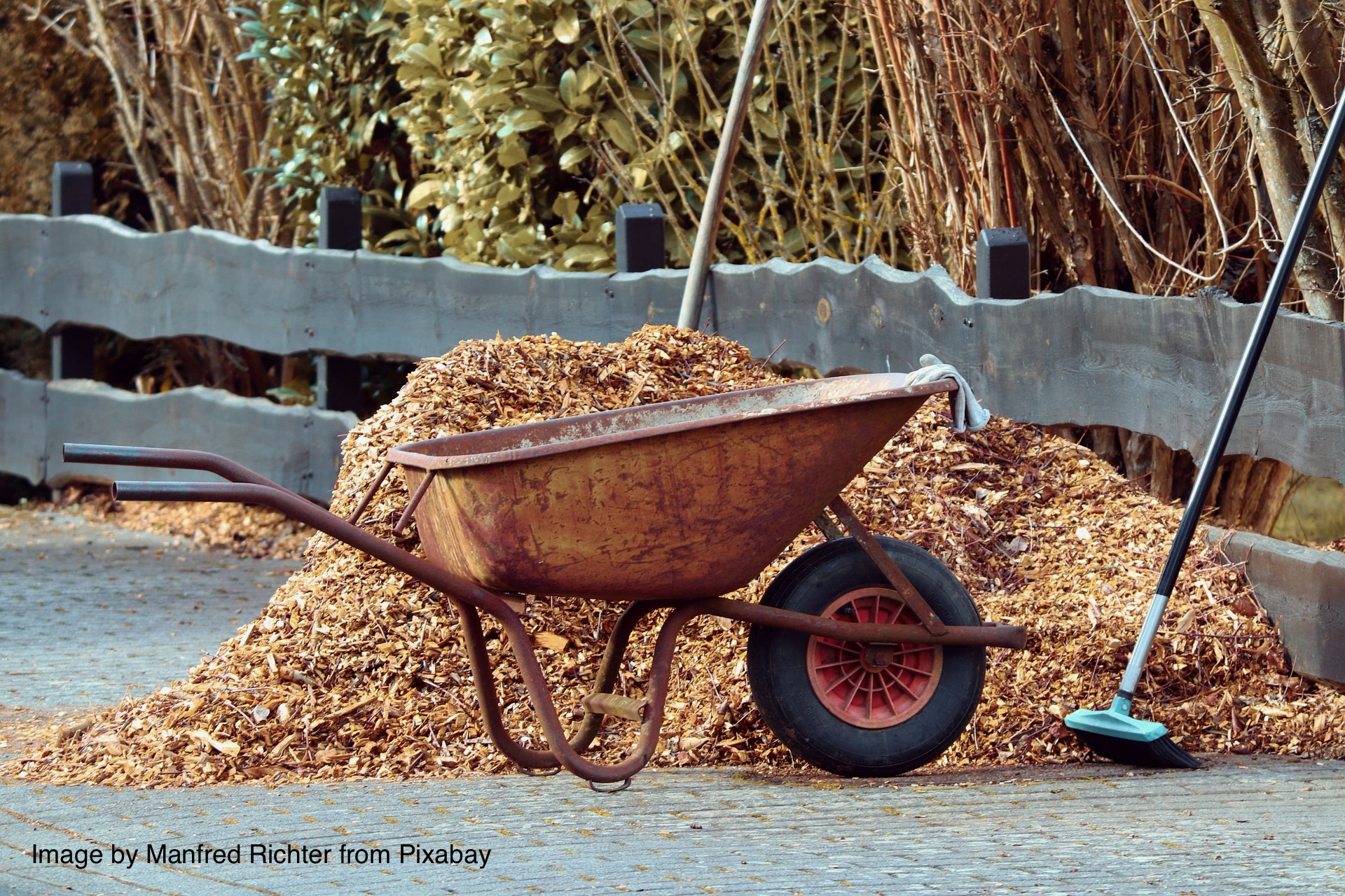Pile of mulch near a wheelbarrow