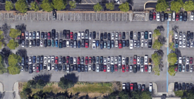 aerial view of parking lot with cars