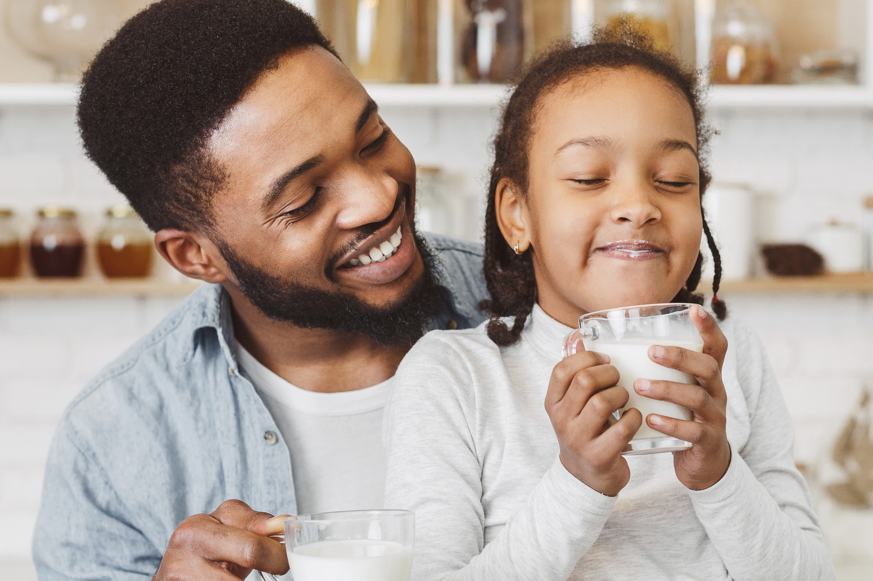 Father and daughter drinking milk