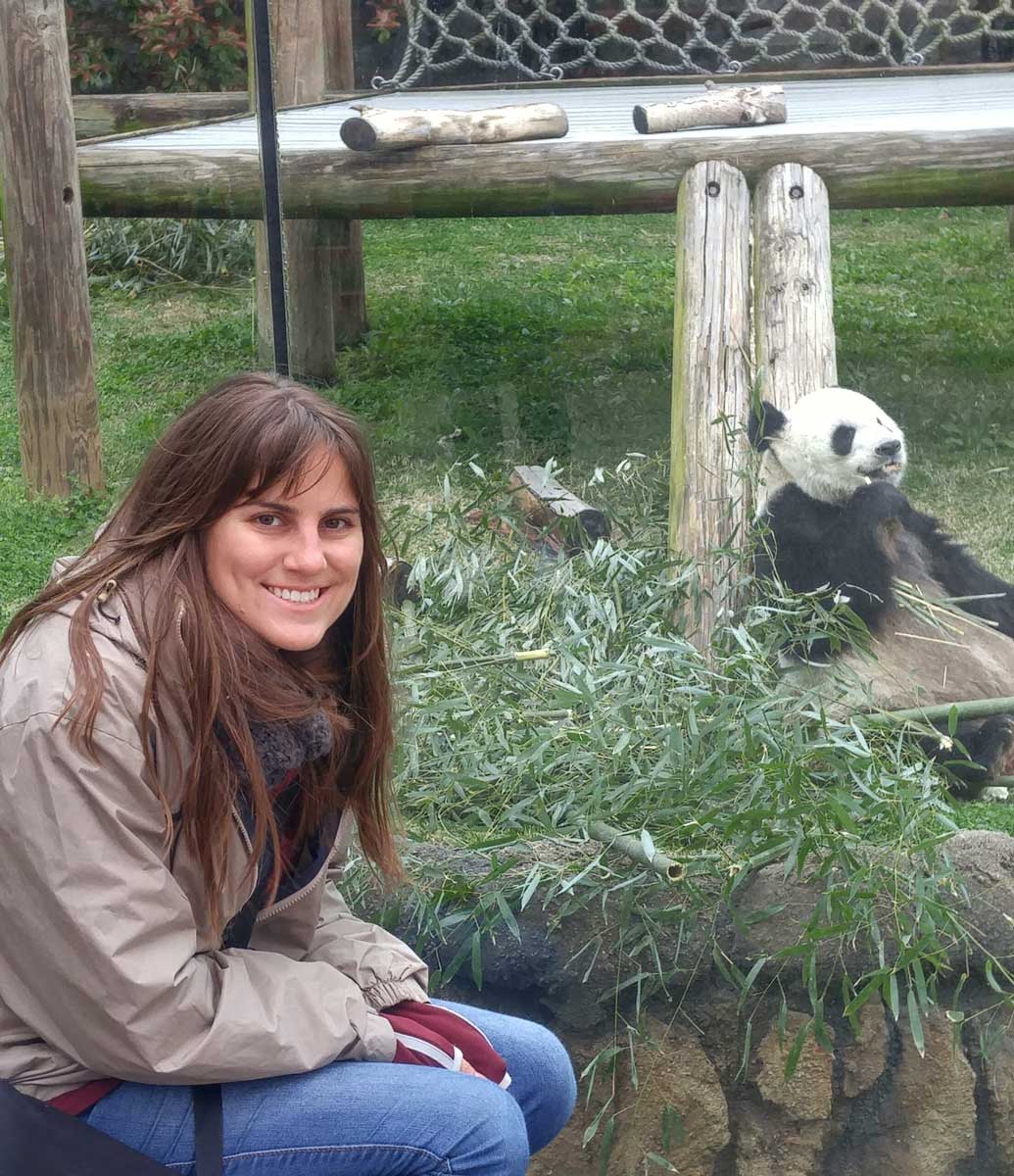 Amelia Christian sitting in front of panda enclosure. 