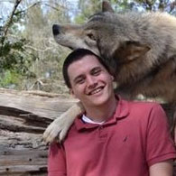 Wolf nuzzling Shawn Trojahn's head.