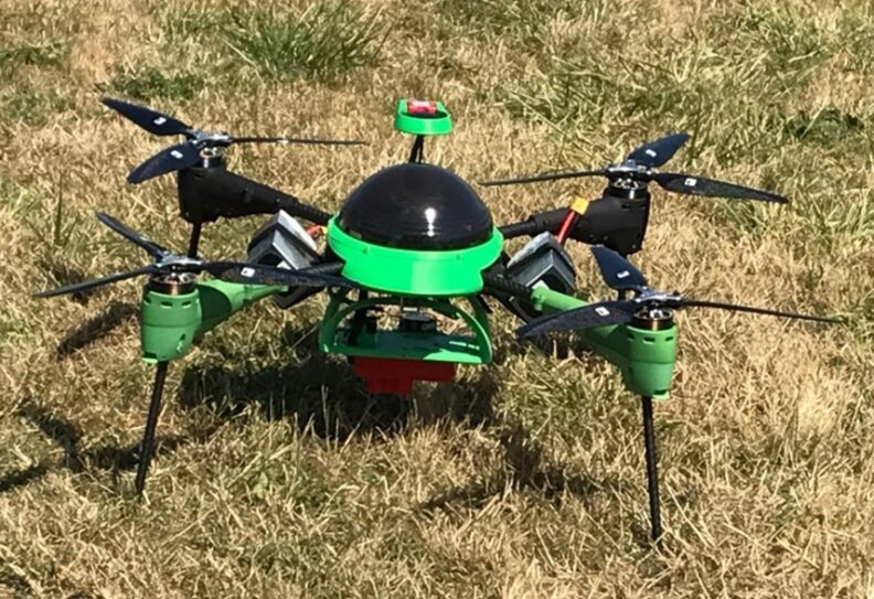 A green and black unmanned aerial vehicle that looks similar to a flying beetle.