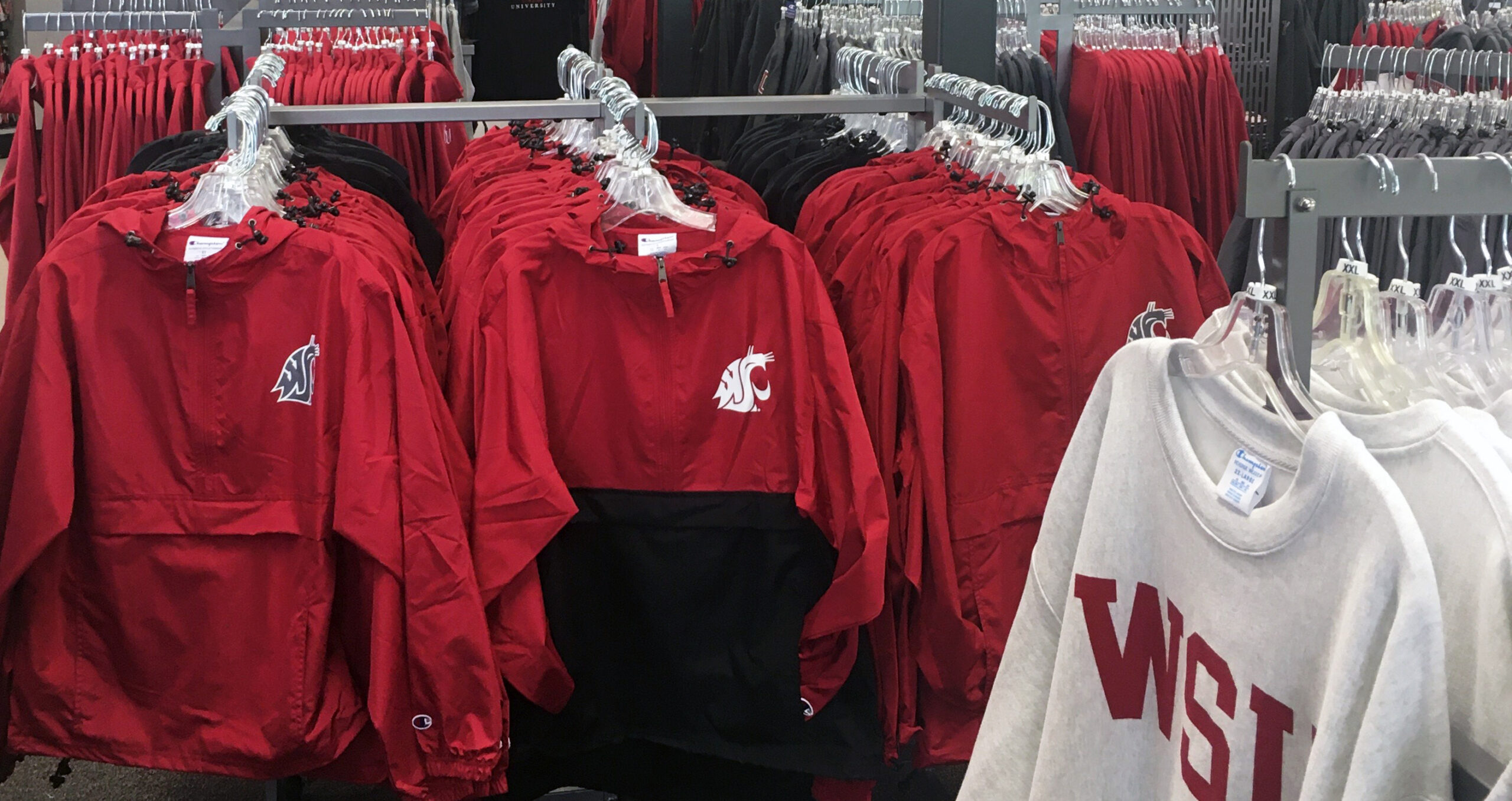 Photograph of a retail rack of WSU branded sweatshirts and jackets