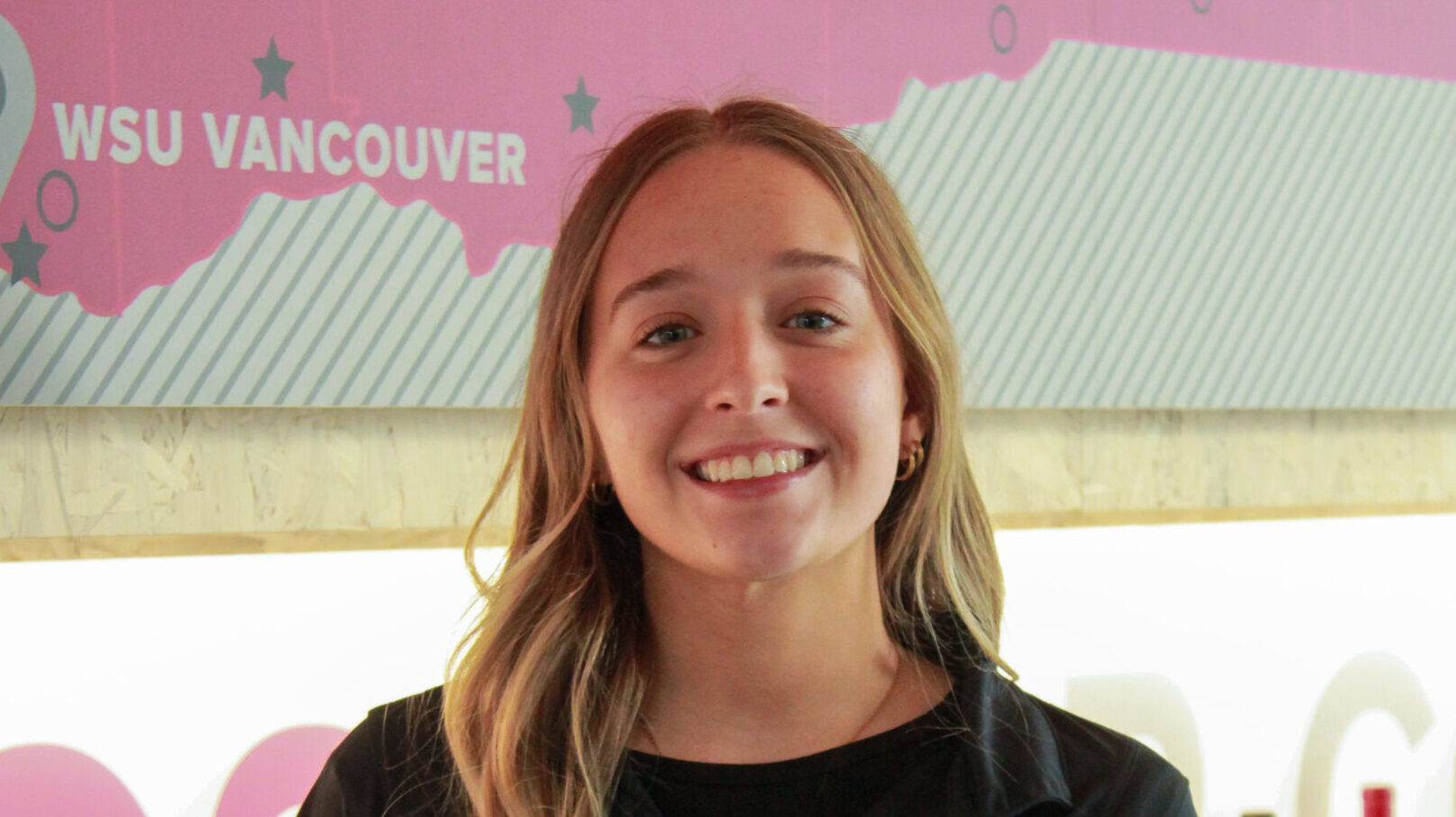 Photo of Karlie in a black Brelsford Visitor Center polo shirt.