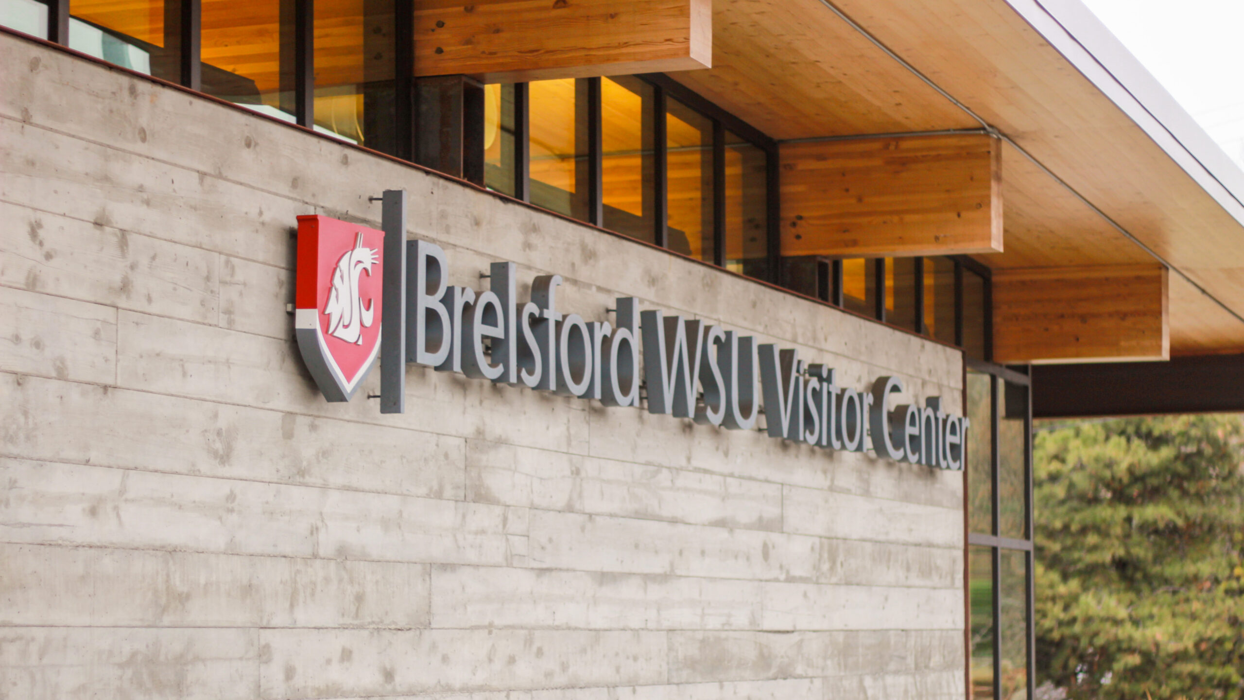 An image of the Brelsford Washington State University Visitor Center's exterior name plaque.