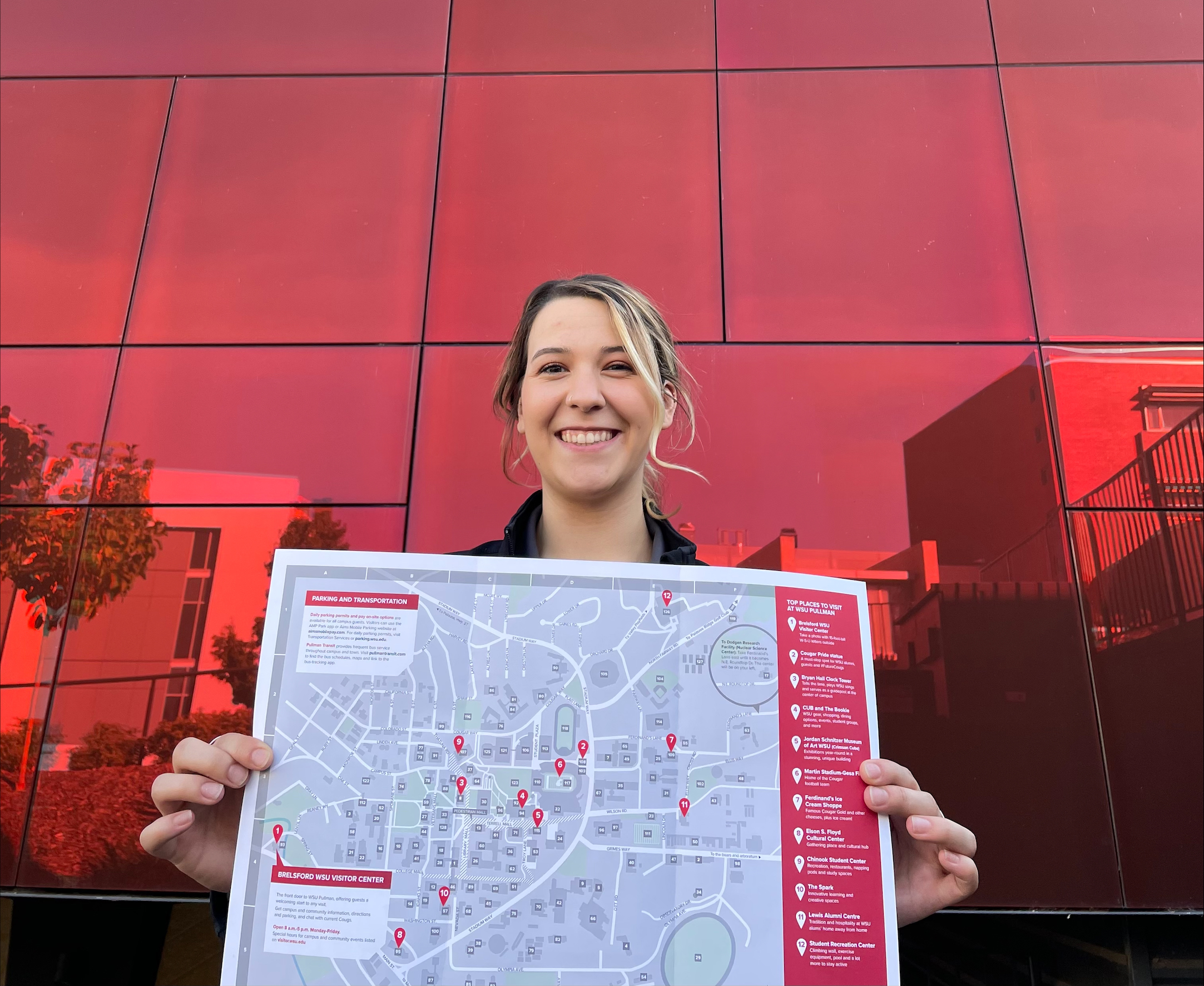 Young lady holding a copy of a campus map
