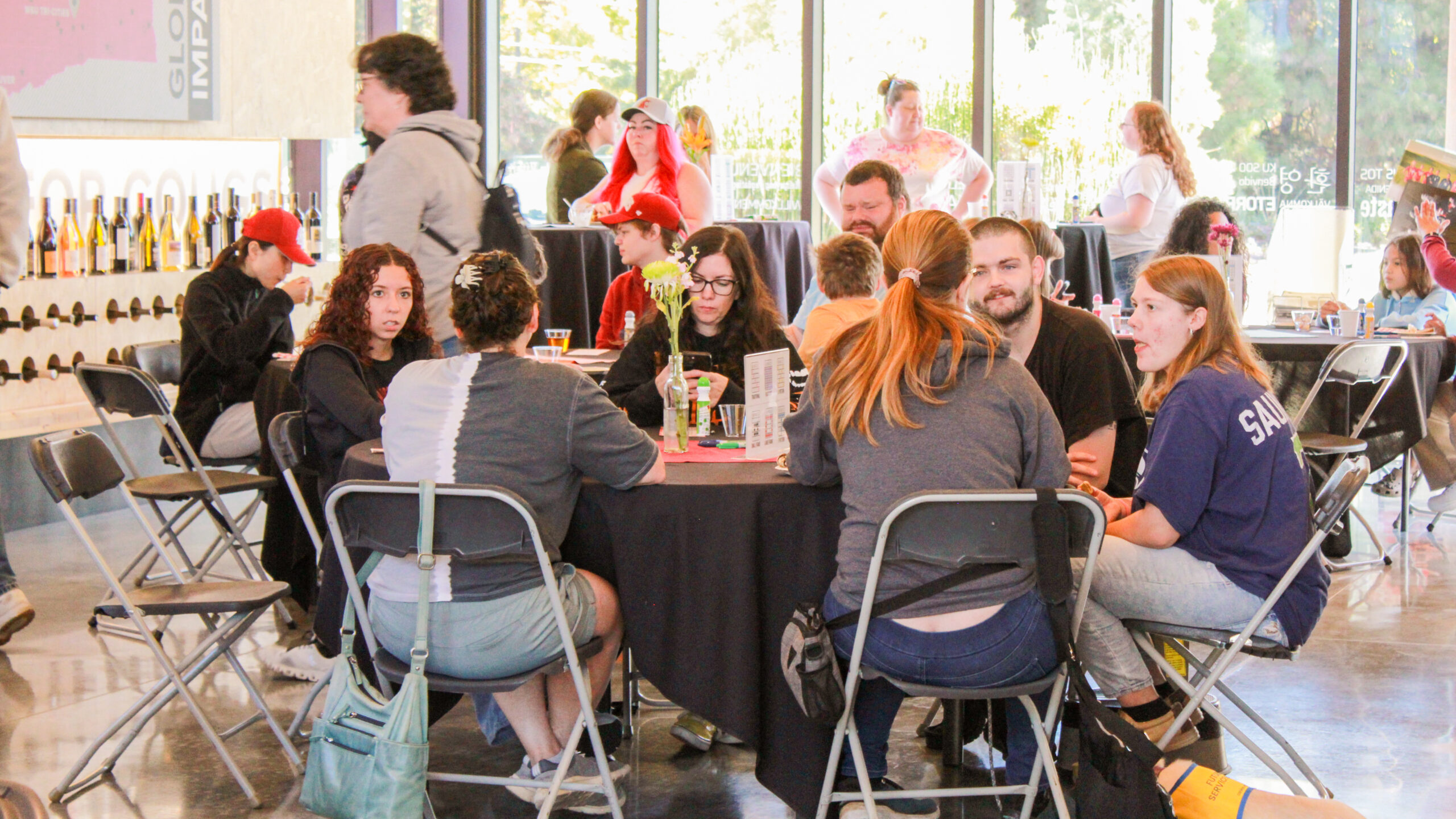 An image of a table of individuals playing Bingo during an event at the Brelsford Washington State University Visitor Center.