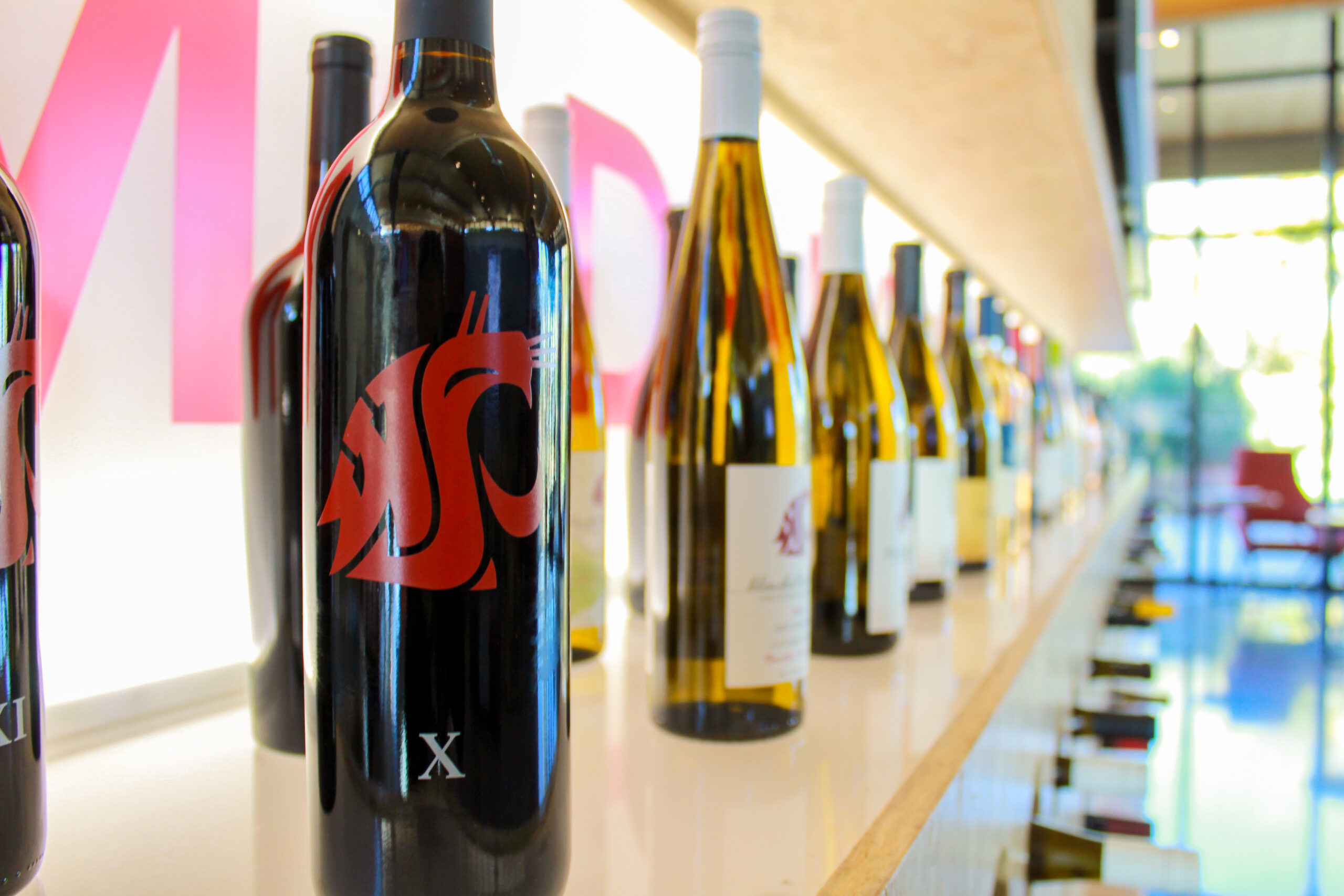 An image of Cougar-connected wines on display inside the Brelsford Washington State University Visitor Center.