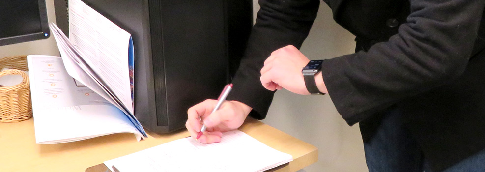 picture of someone signing a form