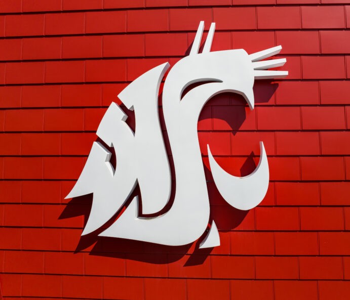 Photo of white WSU cougar logo on a red brick wall. Image link leads to Business Policies and Procedures Manual page.