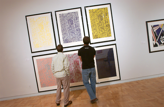 Image of two men viewing a display on the wall at the Schnitzer Museum of Art.
