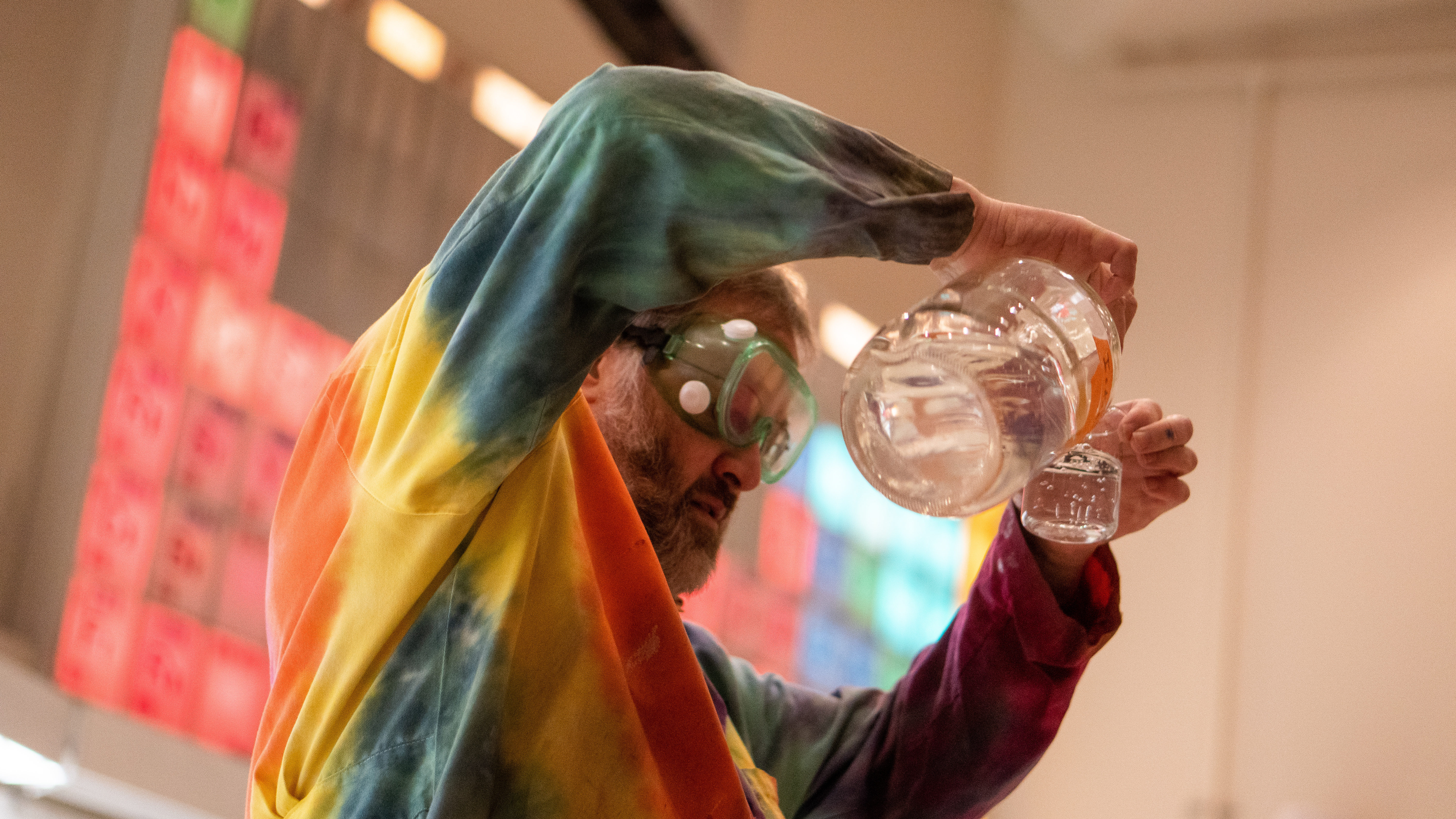 Image of a beaker in hands for a chemistry demonstration
