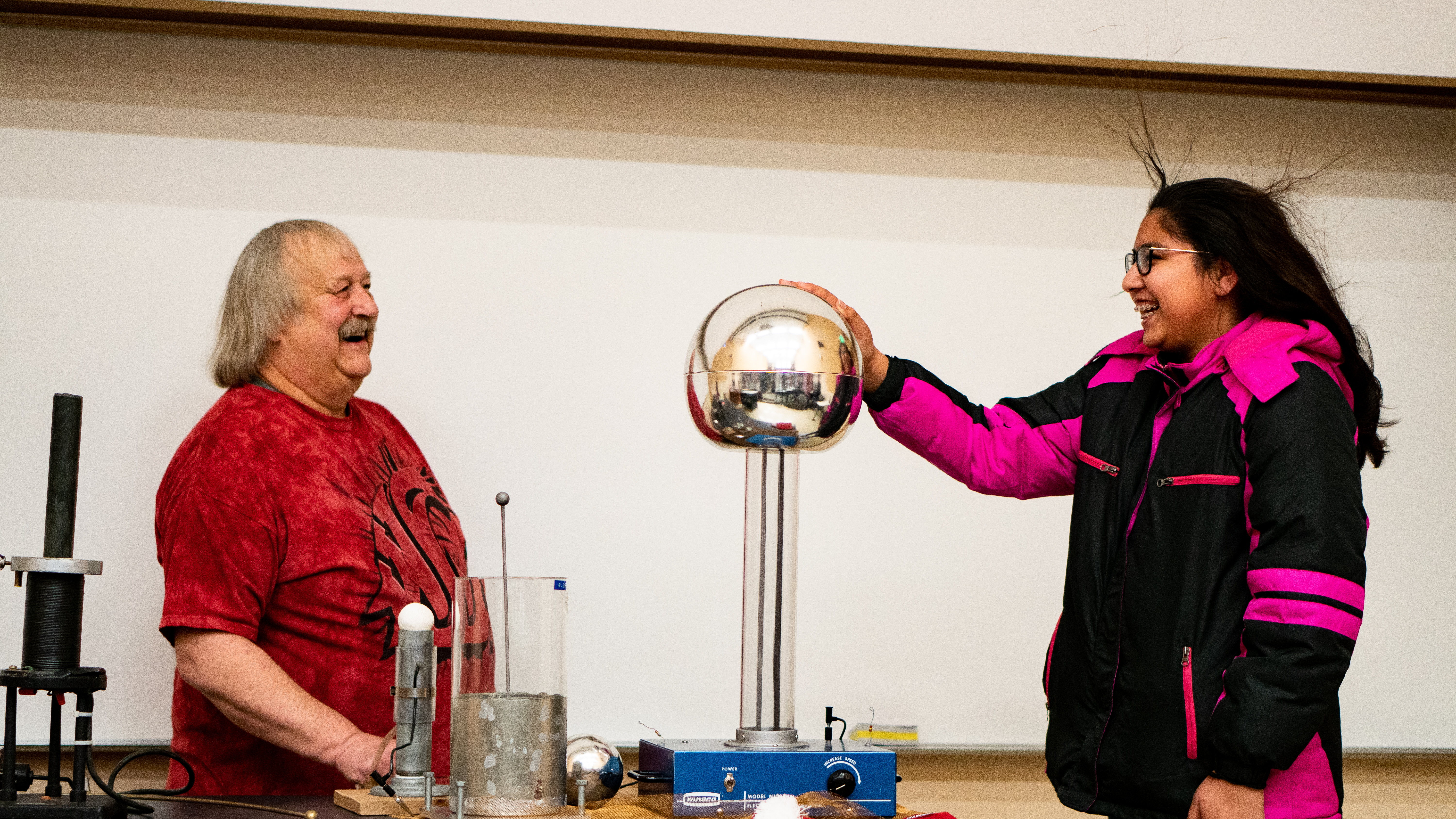 Young lady touching a globe during an experiment.