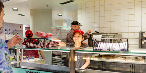 Student employee serving food at a WSU dining center.