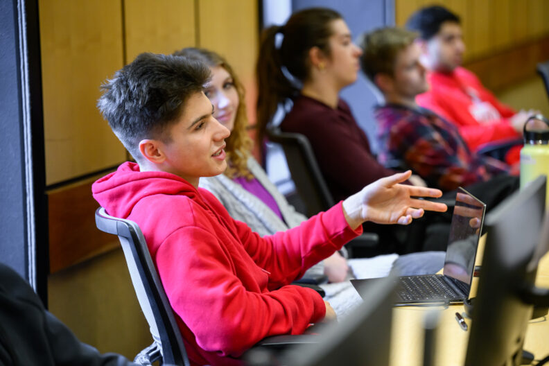 A student asks a question in a social studies class.