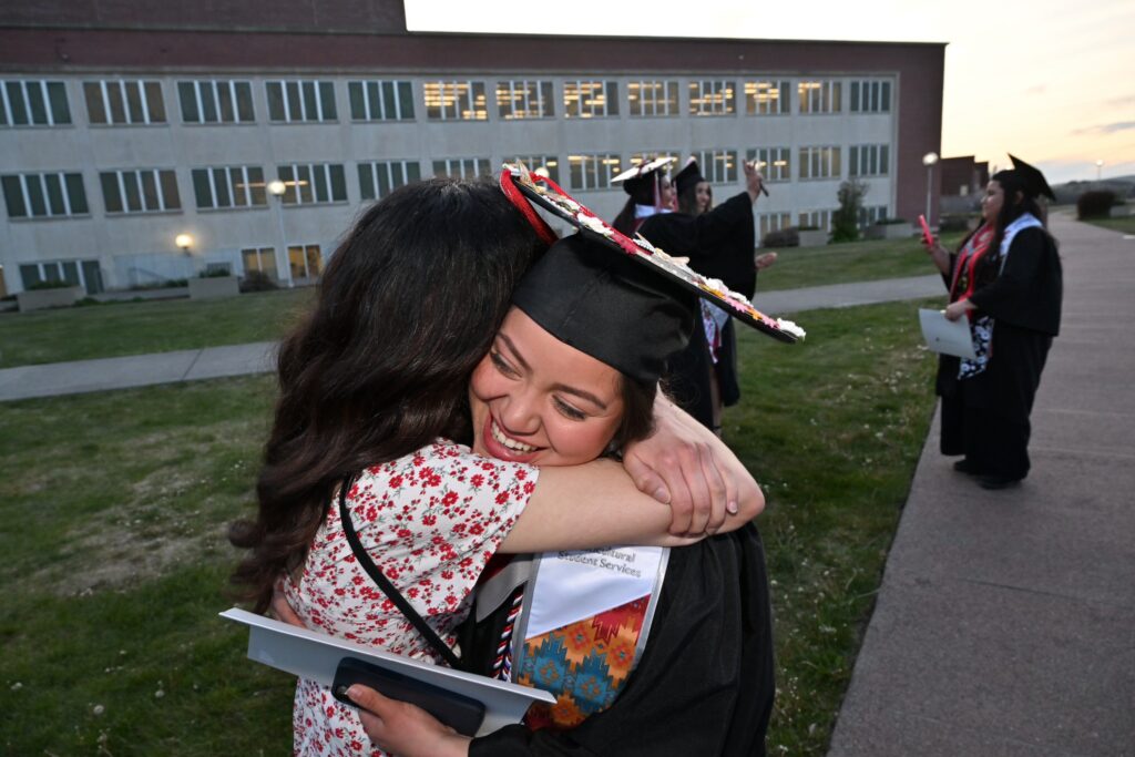 A WSU graduate hugs their parent after the commencement ceremony.