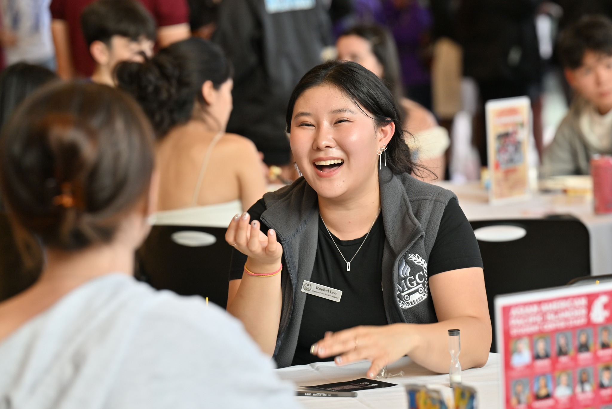 Students sit at a table getting to know each other during orientation week.