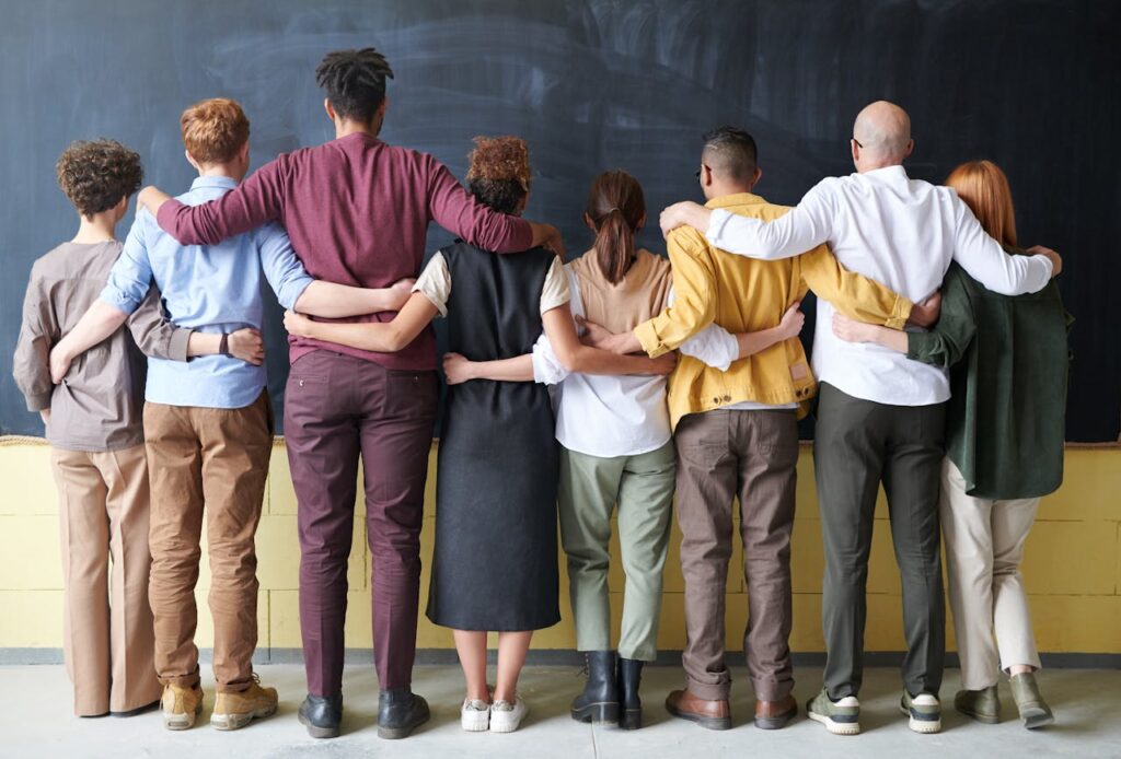 Students gather for a group hug in a classroom.