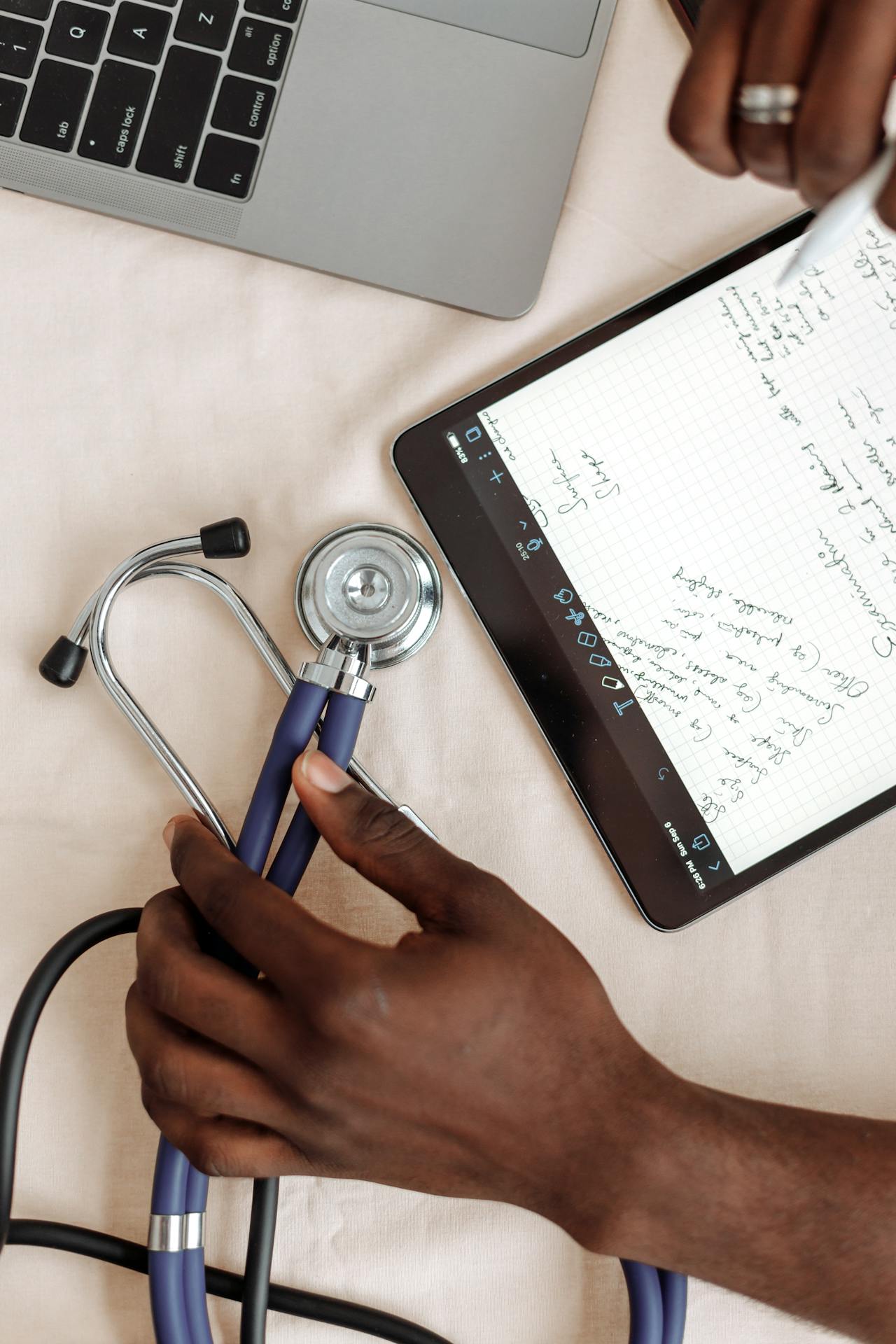 A nurse works on a laptop computer.