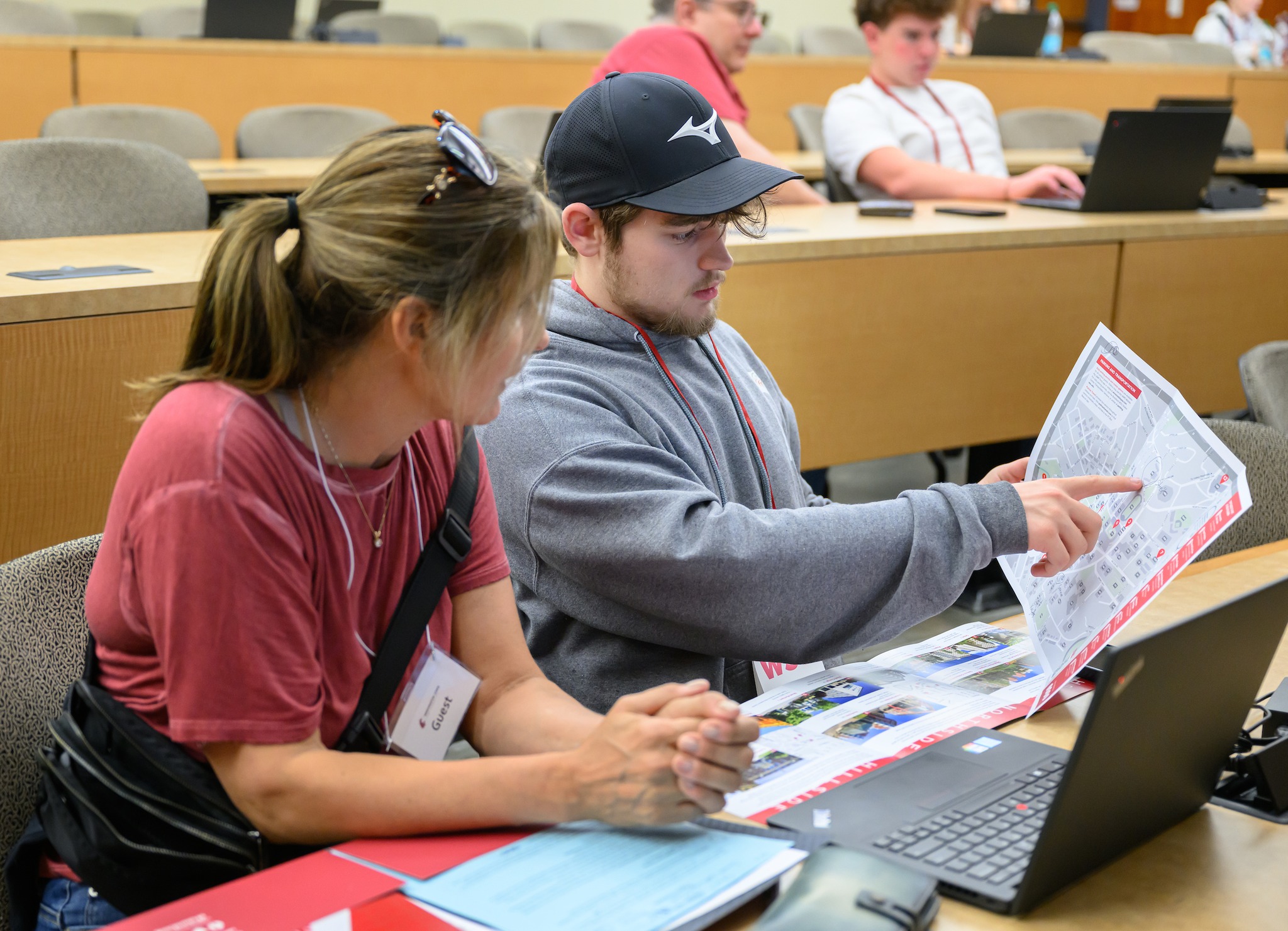 Two students work together in a lecture hall.