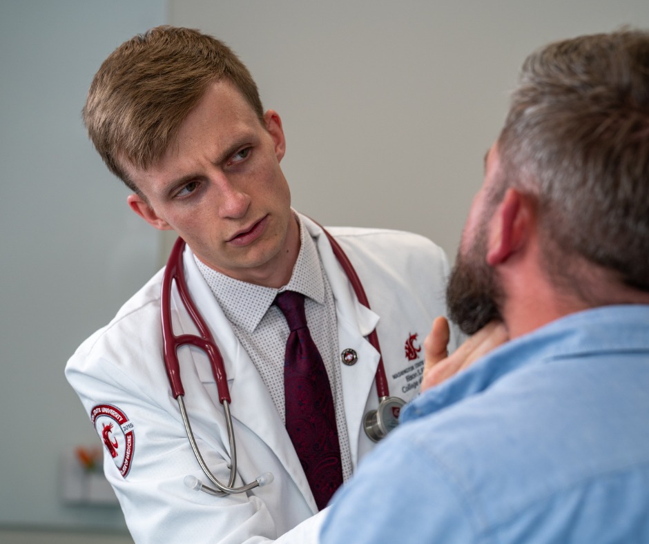 A nurse works on a laptop computer.