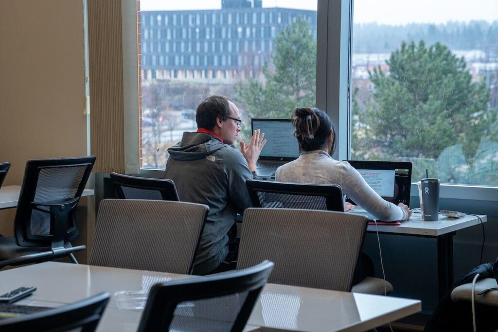 Two WSU Spokane students study together in the library.