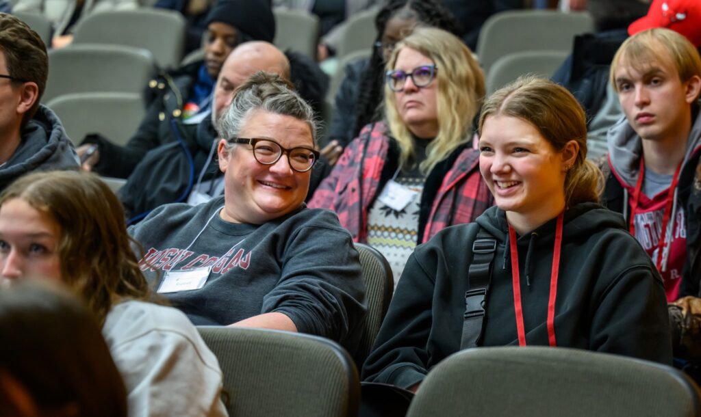 A prospective student and their parent attend a presentation at Experience WSU.