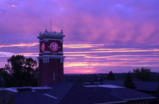 Purple clouds behind Bryan Hall clocktower at twilight