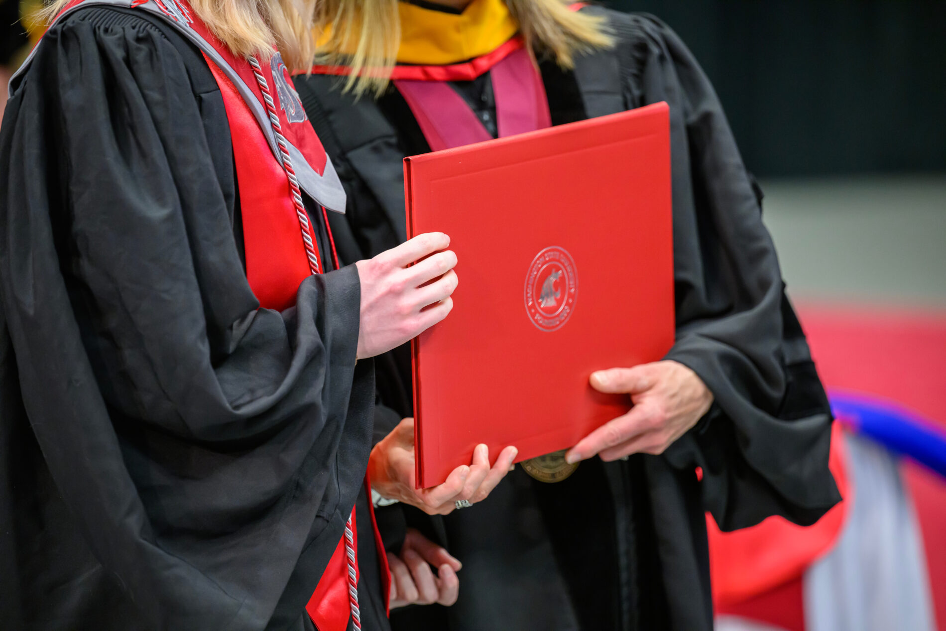 Detail of a diploma cover being held by a recent graduate during a Spring Commencement Ceremony on the campus of Washington State University