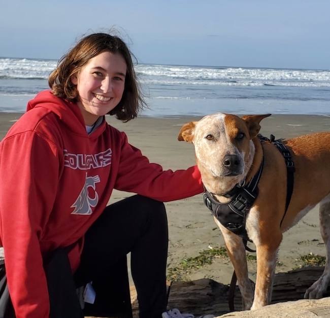 Ellee Nichols with a god at the shoreline