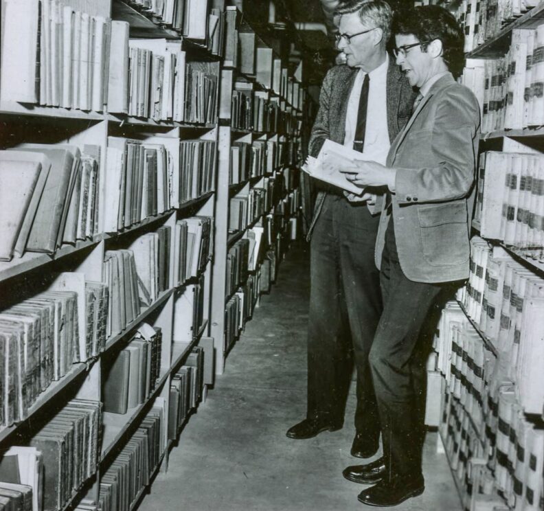 G. Donald Smith (left) and John Elwood look through the MASC Woolf Library collection in 1971.