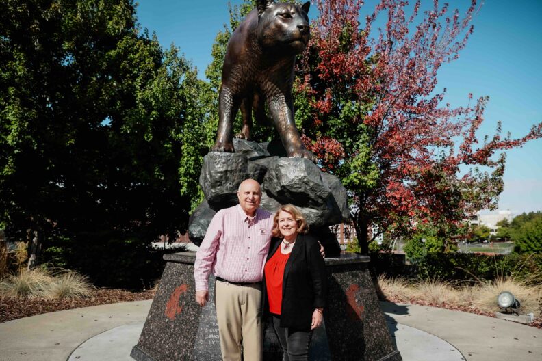 Joel and Colette Loiacono in front of the Cougar Pride statue