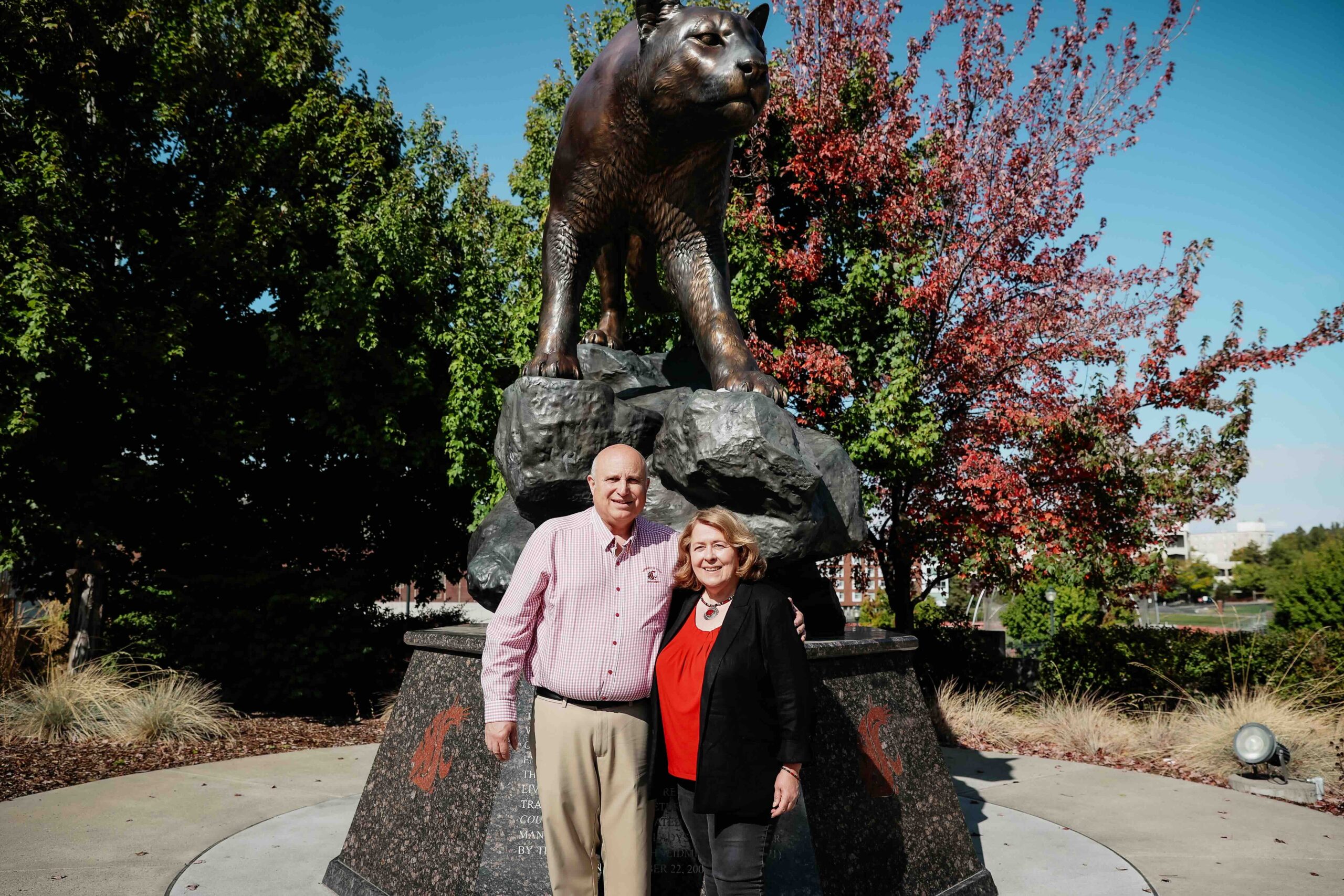 Joel and Colette Loiacono in front of the Cougar Pride statue