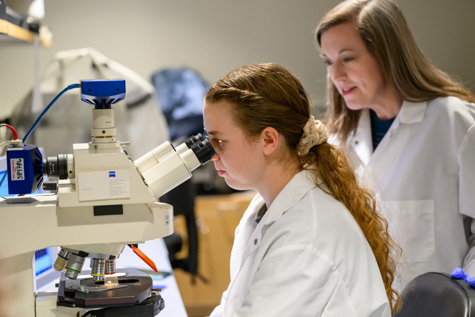 Veterinary Medicine lab of Emily Qualls-Creekmore looking into microscope.