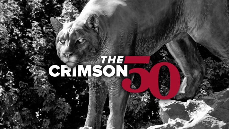 Crimson 50 over an image of the Cougar Pride statue