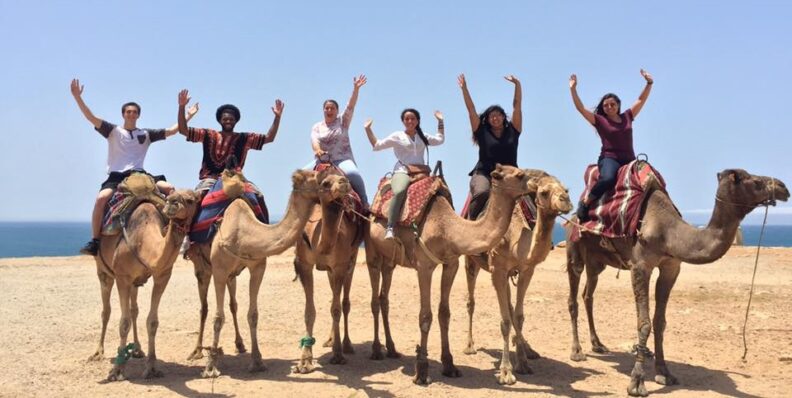 Members of the First Gen Abroad program on camels in Morocco
