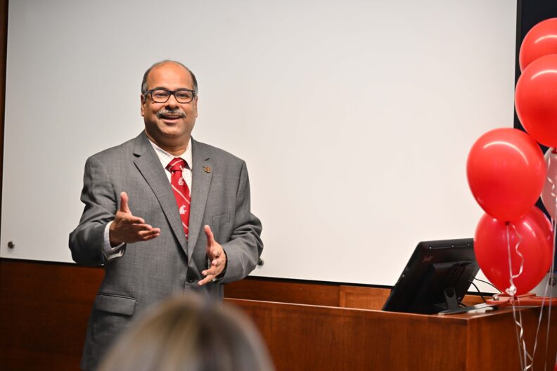 Dean Partha Pande speaking from a lectern.