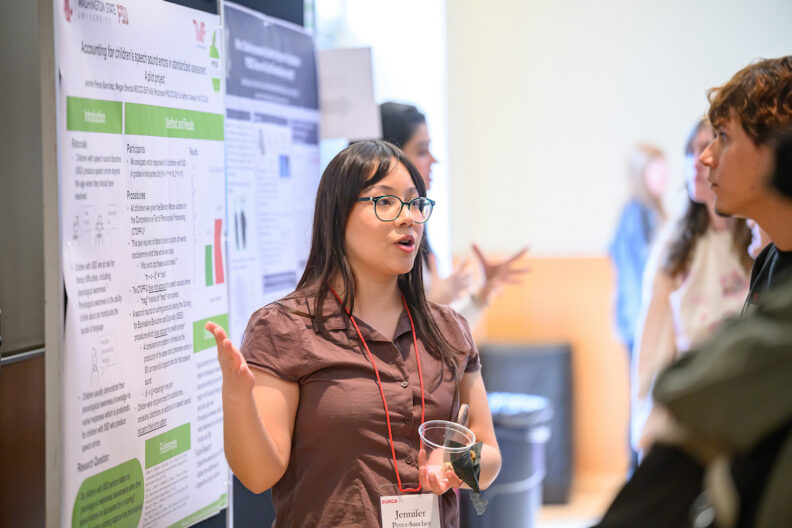 Student presenting her research to a judge.