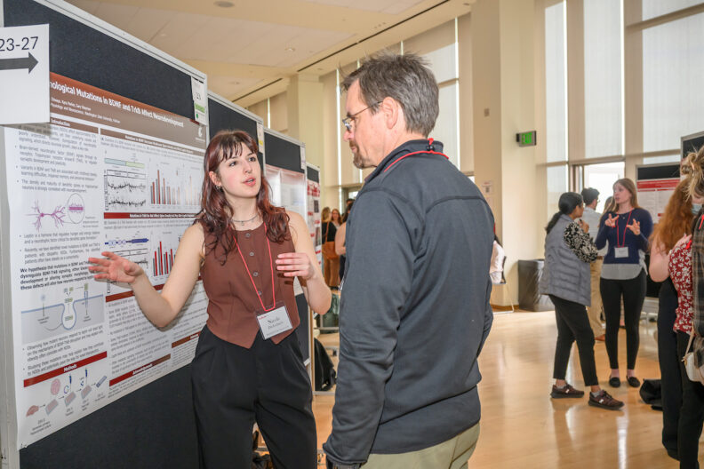 A student presents her research to a judge at SURCA.