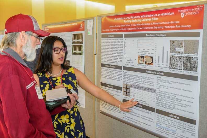 Domenica Gachet (senior) presenting at a previous SURCA to Bob Riech, one of many judges.