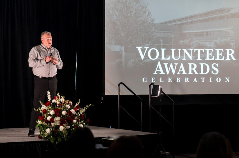 Mike Connell, vice president for Advancement and CEO of the WSU Foundation, addresses the crowd at the 2025 Volunteer Awards Celebration on May 8 at the HAPO Center in Pasco near the campus of WSU Tri‑Cities (photo by Jan Mennenga).