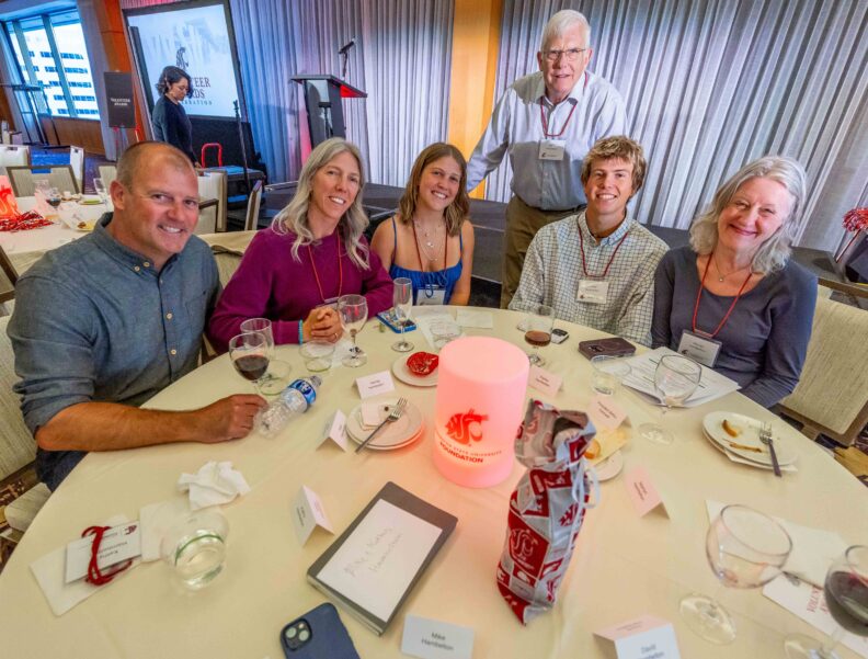 Members of the Hambelton family smile around their banquet table, set with an illuminated WSU Foundation centerpiece, at the 2026 Volunteer Awards Celebration.