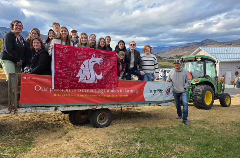 Carson College students on the back of a tractor trailer at Lagriōth Winery